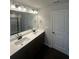 Modern bathroom with double sinks and bright vanity lights at 1151 Park Center Cir, Austell, GA 30168