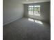 Bright, carpeted bedroom with a large window offering pleasant views and ample natural light at 1151 Park Center Cir, Austell, GA 30168