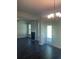Bright living room featuring dark wood floors, a fireplace, and a chandelier at 1151 Park Center Cir, Austell, GA 30168