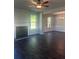 Open-concept living room with a fireplace, stylish dark wood floors, and a dining area at 1151 Park Center Cir, Austell, GA 30168