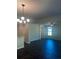 Bright living room featuring dark wood floors, a chandelier, and a ceiling fan at 1151 Park Center Cir, Austell, GA 30168