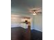 Open-concept living space featuring dark wood floors, white trim, and a view to kitchen at 1151 Park Center Cir, Austell, GA 30168