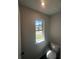 Convenient powder room featuring a window for natural light and a modern toilet at 1151 Park Center Cir, Austell, GA 30168