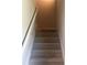 Carpeted stairs with white railing and neutral wall paint, leading to the next level at 1151 Park Center Cir, Austell, GA 30168