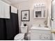 Bathroom features black shower curtain, white toilet and vanity with sink at 1990 Wellbourne Drive Northeast #7 Ne Dr # 7, Atlanta, GA 30324