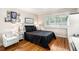 Comfortable bedroom with hardwood floors, shuttered window, and a clean, white chair at 1990 Wellbourne Drive Northeast #7 Ne Dr # 7, Atlanta, GA 30324