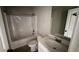 Clean bathroom with tile floors, a bath tub and shower combination, plus a sink and mirror at 265 Sanctuary Dr, Lawrenceville, GA 30046
