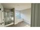 A full bathroom with a tub, separate shower, and window with natural lighting at 265 Sanctuary Dr, Lawrenceville, GA 30046