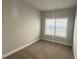 Minimalist bedroom with carpet, baseboard trim, neutral walls, and abundant natural light at 265 Sanctuary Dr, Lawrenceville, GA 30046