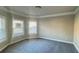 Bright bedroom with carpet, baseboard trim, neutral walls, and abundant natural light at 265 Sanctuary Dr, Lawrenceville, GA 30046