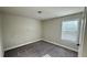 Bedroom featuring carpeted floors, base trim and a window with blinds at 265 Sanctuary Dr, Lawrenceville, GA 30046