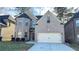Charming two-story brick home with attached two-car garage and manicured front yard at 265 Sanctuary Dr, Lawrenceville, GA 30046