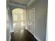 Stunning hallway featuring hardwood floors, crown molding, and a view to the living area at 265 Sanctuary Dr, Lawrenceville, GA 30046