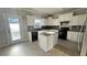 Kitchen with white cabinets, island, granite countertops, stainless steel appliances at 265 Sanctuary Dr, Lawrenceville, GA 30046