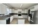 Well-lit kitchen with granite countertops, modern stainless steel appliances, and center island at 265 Sanctuary Dr, Lawrenceville, GA 30046