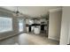 Traditional kitchen featuring white cabinets, an island, black appliances and a neutral backsplash at 265 Sanctuary Dr, Lawrenceville, GA 30046