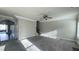 Open-concept living room featuring new carpet and natural light at 265 Sanctuary Dr, Lawrenceville, GA 30046