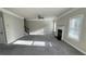 Spacious living room featuring large windows, a fireplace, and carpeted floors at 265 Sanctuary Dr, Lawrenceville, GA 30046