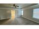 A large main bedroom with two windows, ceiling fan, and access to the en suite bathroom at 265 Sanctuary Dr, Lawrenceville, GA 30046