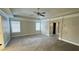 Primary bedroom with tray ceiling, carpet and two large windows at 265 Sanctuary Dr, Lawrenceville, GA 30046