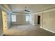 A large main bedroom with two windows, ceiling fan, and access to the en suite bathroom at 265 Sanctuary Dr, Lawrenceville, GA 30046