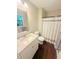 Bright bathroom with modern vanity, granite countertop, and wood-look flooring at 2661 Throatlatch Sw Ln, Marietta, GA 30064