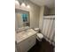 Bright bathroom with modern vanity, granite countertop, and wood-look flooring at 2661 Throatlatch Sw Ln, Marietta, GA 30064