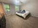 Cozy bedroom with neutral carpet and two large windows for natural light at 2661 Throatlatch Sw Ln, Marietta, GA 30064