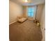 Bright bedroom featuring a small crib near a window with ample natural light at 2661 Throatlatch Sw Ln, Marietta, GA 30064