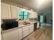 Bright kitchen features white cabinets, granite countertops, and stainless steel appliances at 2661 Throatlatch Sw Ln, Marietta, GA 30064