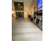An open-concept living room with a stone fireplace and light wood flooring at 2661 Throatlatch Sw Ln, Marietta, GA 30064