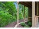 View of backyard landscaping featuring a stone walkway and a mulched area and lush trees at 2765 Prado Ln, Marietta, GA 30066