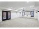 Spacious basement featuring carpet flooring, large windows, french doors, and a projector with a retractable screen at 2765 Prado Ln, Marietta, GA 30066