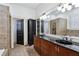 Bathroom featuring a double vanity with black countertop, tiled shower and flooring at 2765 Prado Ln, Marietta, GA 30066