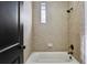Bathroom with tiled shower/tub combination featuring a small window and oil rubbed bronze shower head and faucet at 2765 Prado Ln, Marietta, GA 30066