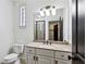 This bathroom offers a large mirror, sink vanity, toilet, tiled shower and neutral paint at 2765 Prado Ln, Marietta, GA 30066