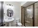 Bathroom with vessel sink, framed mirror, and a glass-enclosed shower featuring decorative tiling at 2765 Prado Ln, Marietta, GA 30066