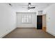 A spacious bedroom features neutral carpet, a window with shutters, base molding and white walls at 2765 Prado Ln, Marietta, GA 30066