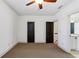 A spacious bedroom featuring neutral carpet, base molding, and a ceiling fan, and has two doors at 2765 Prado Ln, Marietta, GA 30066