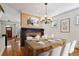 Dining room with table set for dinner, wood floors, fireplace, and decorative light at 2765 Prado Ln, Marietta, GA 30066