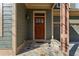 Inviting front entrance with a wooden door, stone steps, and a decorative bench at 2765 Prado Ln, Marietta, GA 30066