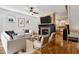 Bright living room with fireplace, flat screen TV, and hardwood floors open to kitchen area at 2765 Prado Ln, Marietta, GA 30066