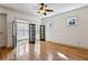 Sunlit living room featuring hardwood floors and black french doors leading to a sunroom at 2765 Prado Ln, Marietta, GA 30066