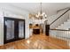 Living room showing wooden floors, double doors, staircase, and entry to kitchen at 2765 Prado Ln, Marietta, GA 30066