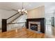 View of the living room shows the fireplace, wooden floors, staircase, and plenty of light at 2765 Prado Ln, Marietta, GA 30066