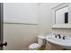 A powder room featuring a white toilet and a pedestal sink with white beadboard walls at 2765 Prado Ln, Marietta, GA 30066
