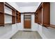A large walk-in closet features dark wood shelving with carpeted floors and neutral paint at 2765 Prado Ln, Marietta, GA 30066