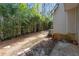 View of the backyard featuring bamboo trees and an air conditioning unit at 5090 Leeshire Trce, Tucker, GA 30084