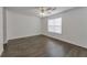 Bright and airy bedroom featuring hardwood floors and a ceiling fan at 5090 Leeshire Trce, Tucker, GA 30084