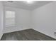 Bright bedroom featuring hardwood floors and a window providing natural light at 5090 Leeshire Trce, Tucker, GA 30084